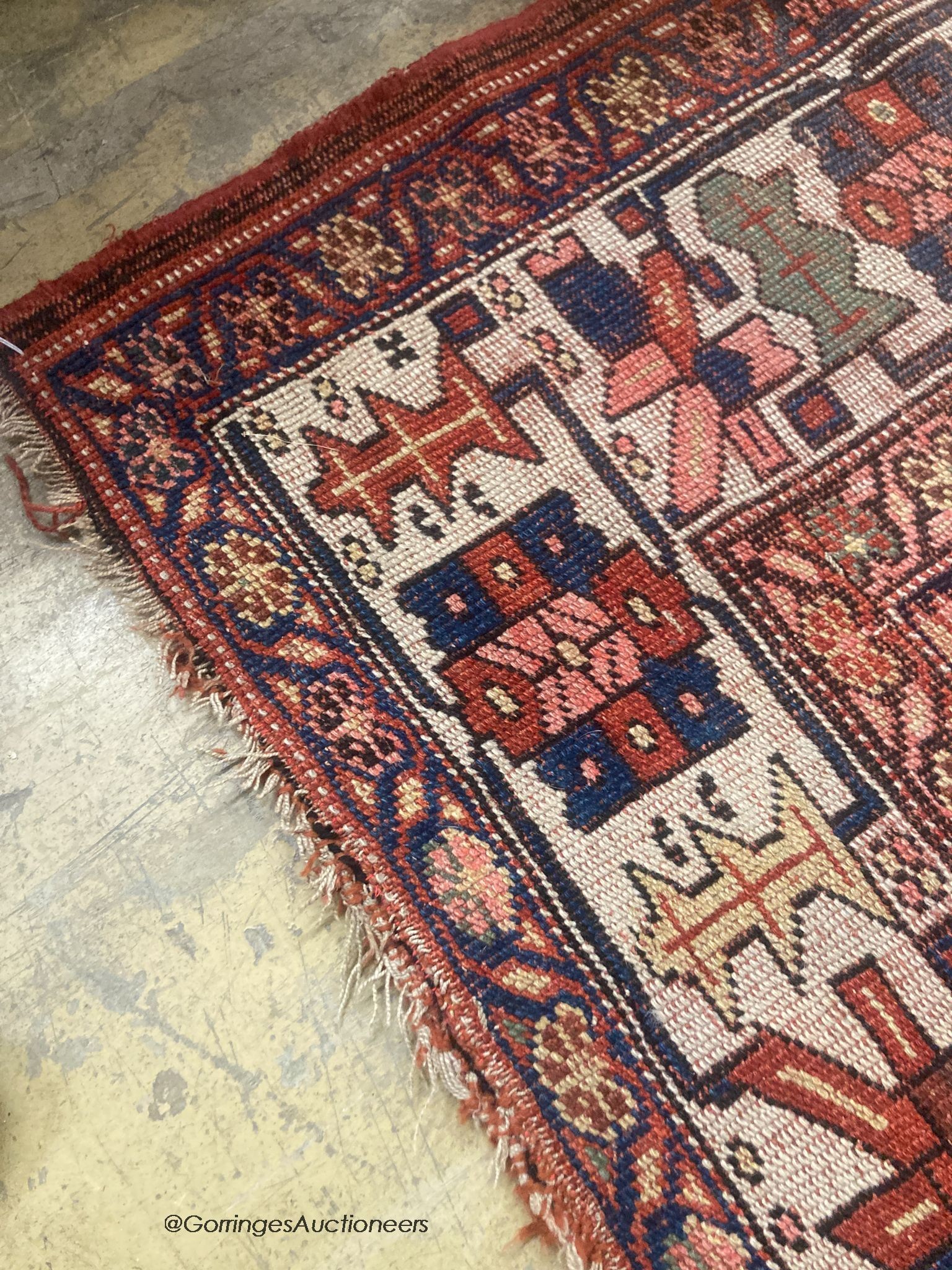 A Caucasian red ground rug, 218 x 112cm